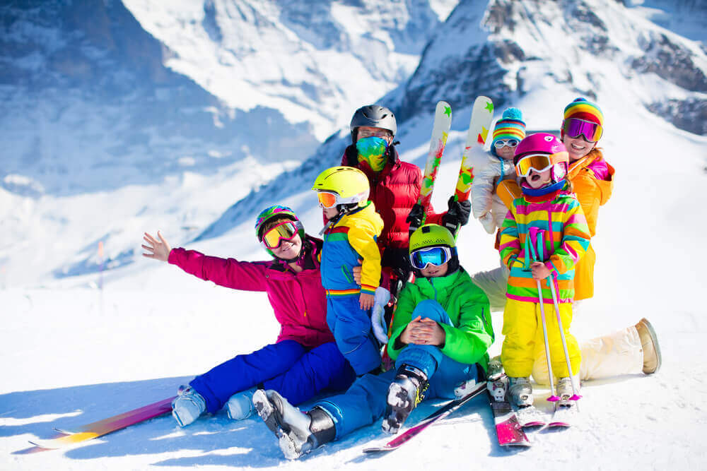 plan your trip. Family ski vacation. Group of skiers in Swiss Alps mountains.