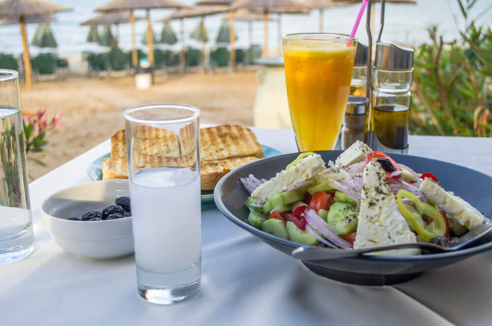 travel to europe. Greek food and drinks served in a restaurant near beach