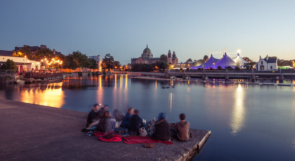 during Galway Art Festival with Big Top and Cathedral on the bank of Corrib river in Galway, Ireland. Ireland road trip