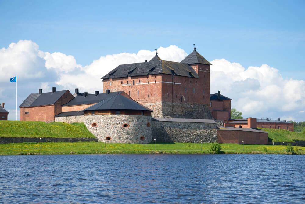 Trip to Finland. Medieval fortress of Hameenlinna on the shore of Vanajavesi lake on a July day. Finland