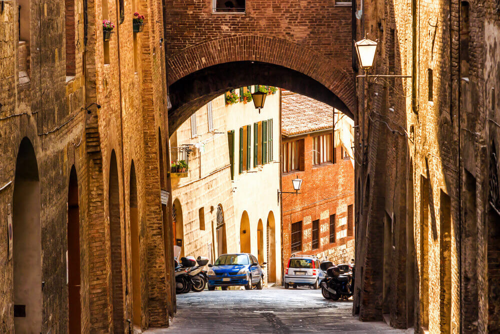 planning a trip to Italy. Old street in medieval Siena, Tuscany, Italy.