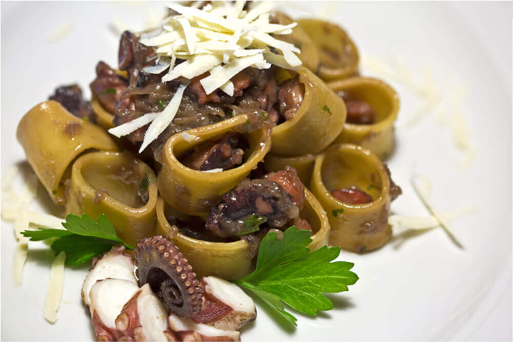 Pasta called calamarata with octopus and parsley. attractions in Italy