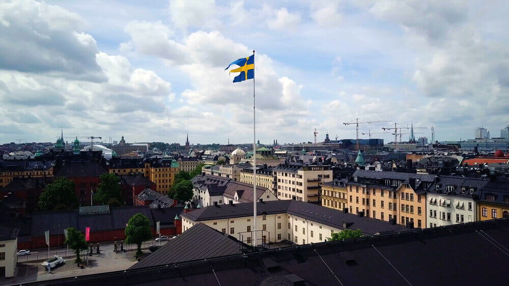 trip to Sweden. Swedish Flag with aerial panoramic view of The Old Town , Gamla Stan , Stockholm , Sweden.